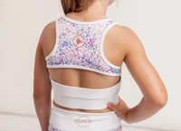 White sports crop with colorful sequin details and matching shorts on a plain background