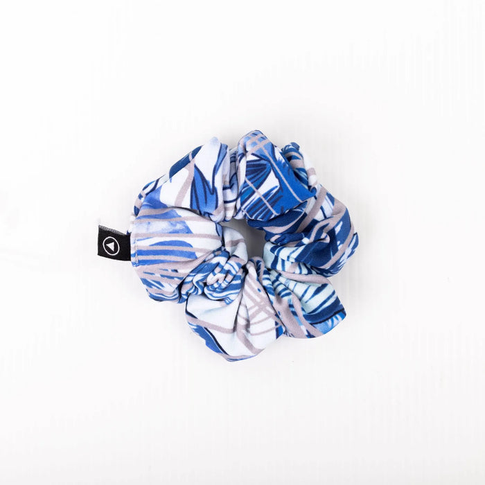 Scrunchie in Blue Monstera pattern on a plain white background