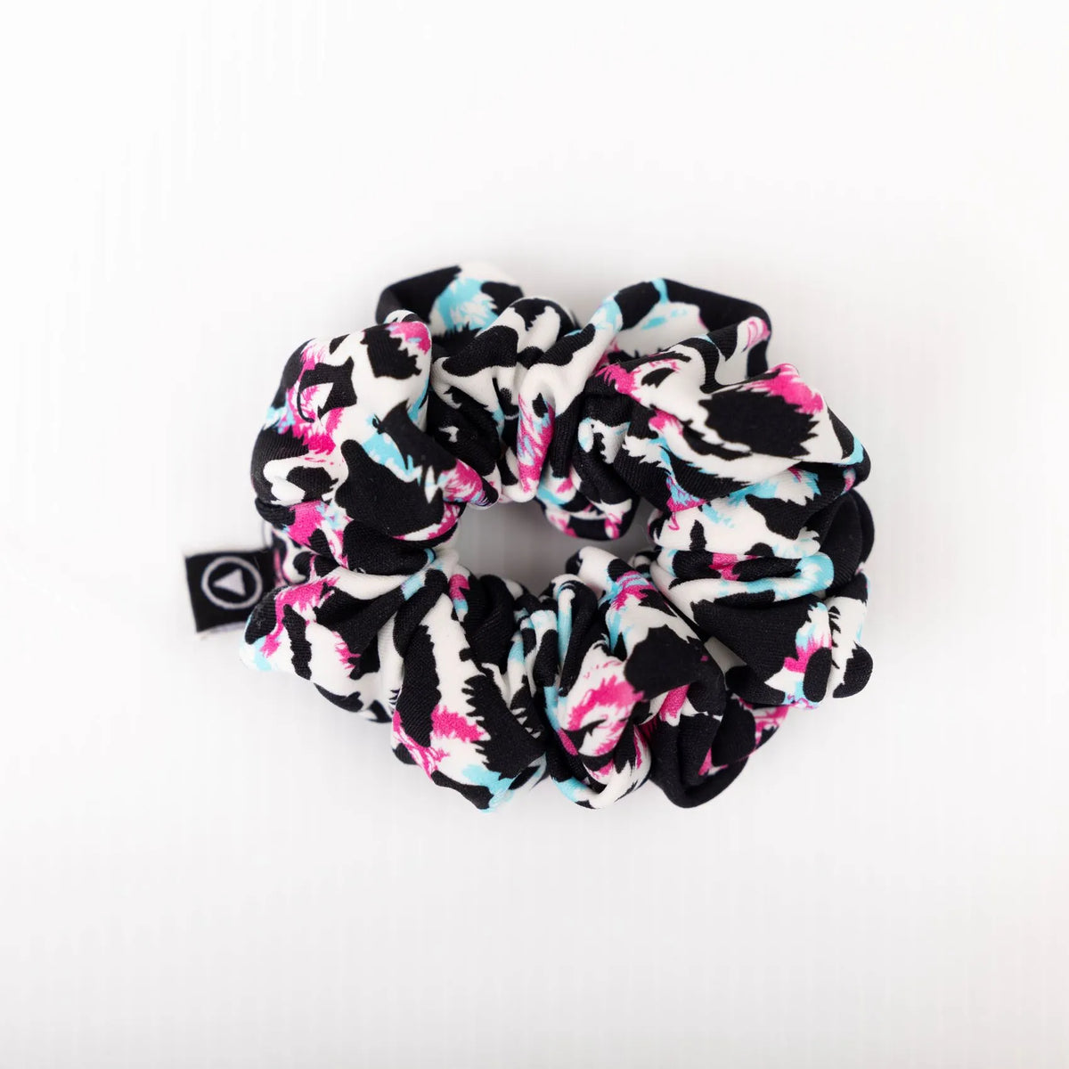 Scrunchie in multi coloured leopard print on a plain white background