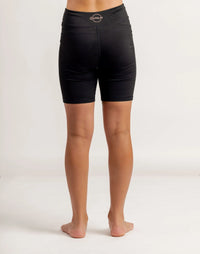 Girl wearing black Get Moving Bike Shorts on a white background