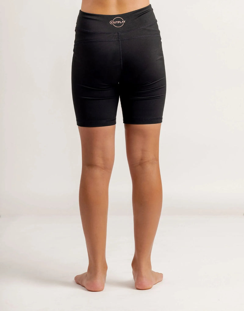 Girl wearing black Get Moving Bike Shorts on a white background