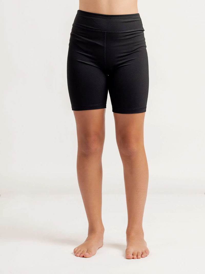 Girl wearing black Get Moving Bike Shorts on a white background