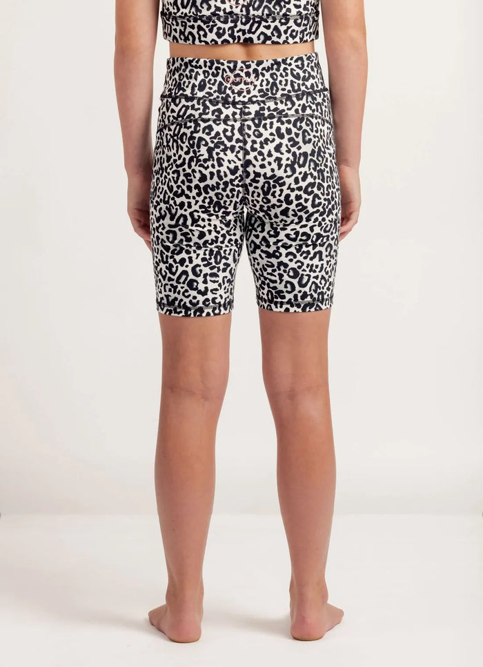 Person wearing Snow Leopard print get moving bike shorts on a plain background