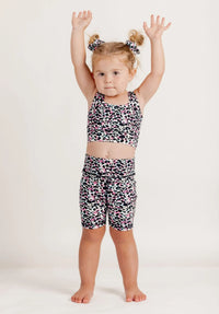 Girl wearing an Envy Me Multi coloured leopard print crop and Get Moving bike shorts set on a white background