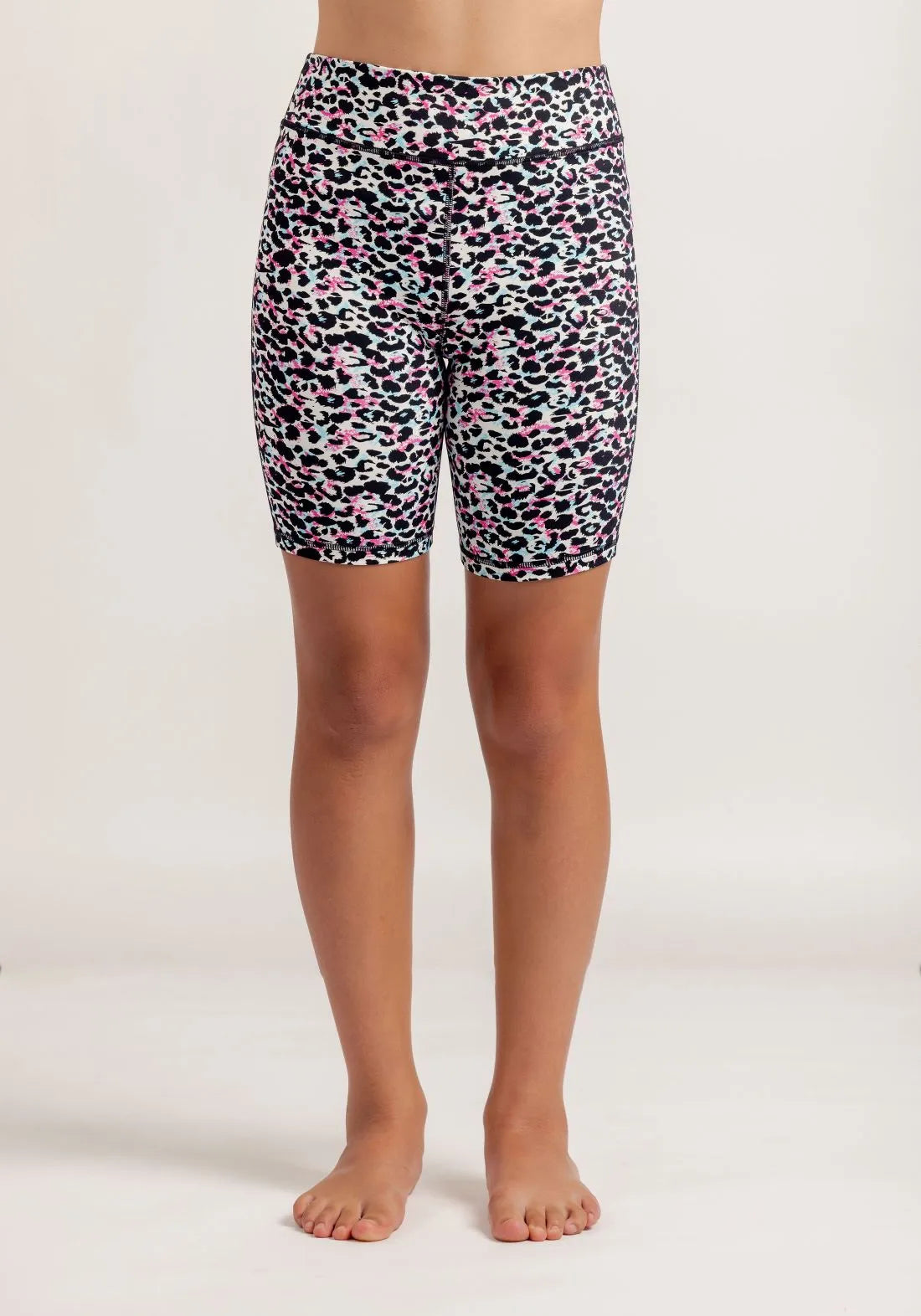 Girl wearing Get Moving Multi coloured leopard print bike shorts on a white background