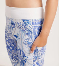 Close up of waist band and pockets on Blue Monstera Limitless leggings on white background