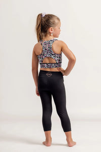 Young girl wearing a Multi coloured leopard print crop top and black Go Get Em 3/4 leggings on a white background