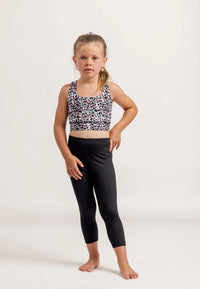 Young girl wearing a Multi coloured leopard print crop top and black Go Get Em 3/4 leggings on a white background