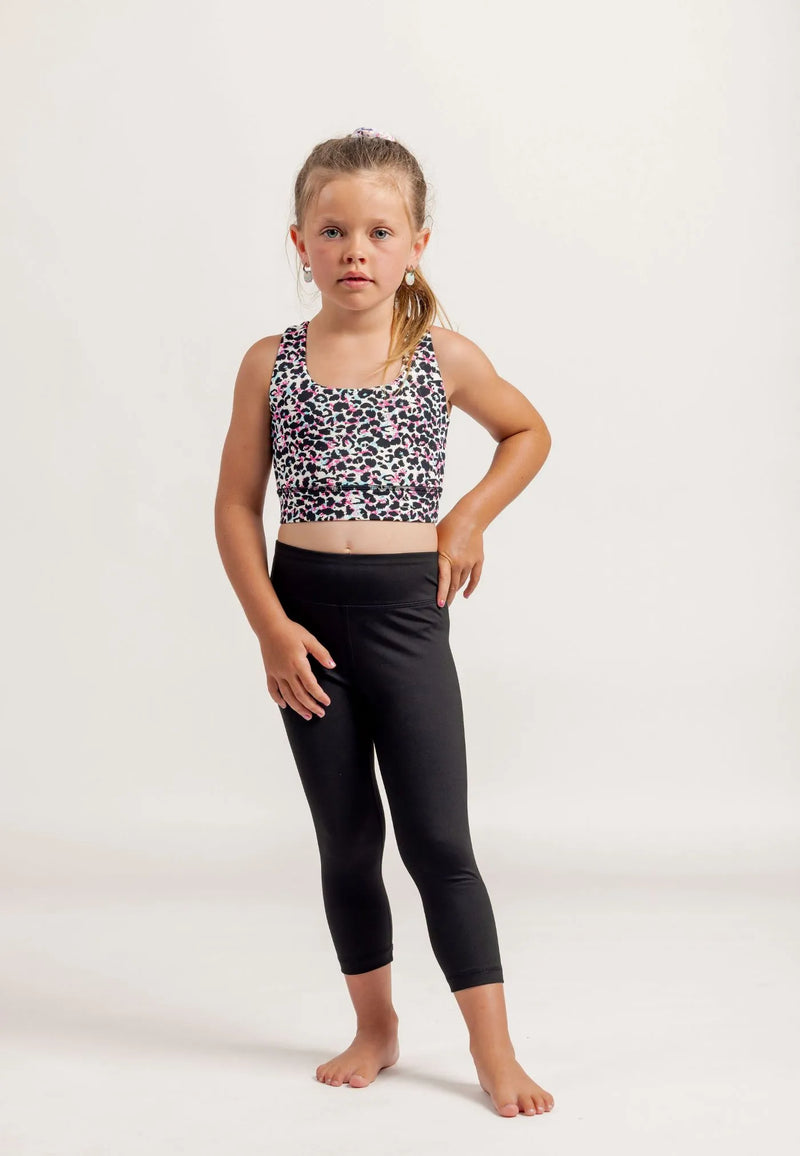 Young girl wearing a Multi coloured leopard print crop top and black Go Get Em 3/4 leggings on a white background