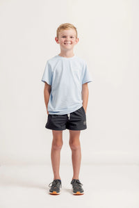 Boy wearing a Gametime light blue t-shirt with a logo, against a plain background