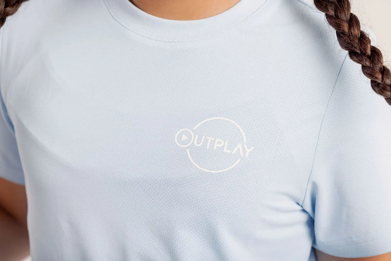 Person wearing a Gametime light blue t-shirt with 'OUTPLAY' logo